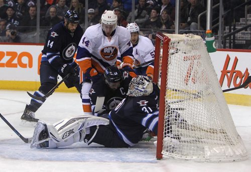 New York Islancers #14 tries to get the puck past Winnipeg Jest goalie ONDREJ PAVELEC (31) during the 1st period of their game at the MTS Centre Tuesday.  March 04, 2014 Ruth Bonneville / Winnipeg Free Press