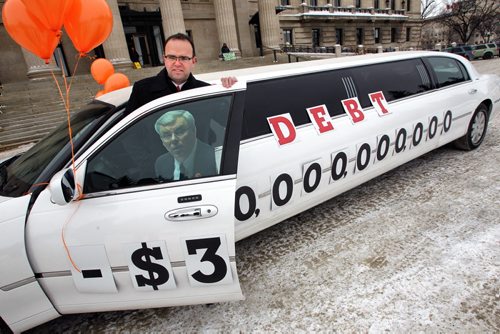 Colin Craig, with the Canadian Taxpayers Federation, and the limo with the $30 billion debt threshold recently crossed by the provincial government plastered on its side in front of the Legislative Building this morning. 140305 - March 5, 2014 MIKE DEAL / WINNIPEG FREE PRESS