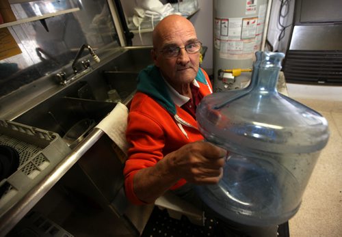 Mike Perkin sits in the "dry" kitchen at the General Sir Sam Steel Legion Wednesday. The north end institution is already facing bankruptsy, and now has a frozen water line for the second time. See Aldo Santin story. March5, 2014 - (Phil Hossack / Winnipeg Free Press)