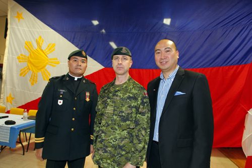 Canadian Forces Appreciation night for DART at the Filipino Canadian Seniors Hall on Euclid. Major Robert Meade came in from Ontario and was part of the Dart Team that helped in the last disaster in the Philippines. In photo Meade and Jon Reyes. BORIS MINKEVICH/WINNIPEG FREE PRESS  MARCH 5, 2014Canadian Forces Appreciation night for DART at the Filipino Canadian Seniors Hall on Euclid. Major Robert Meade came in from Ontario and was part of the Dart Team that helped in the last disaster in the Philippines. In photo Capt. Roy Allan C. Laudenorio, Major Robert Meade and Jon Reyes. BORIS MINKEVICH/WINNIPEG FREE PRESS  MARCH 5, 2014