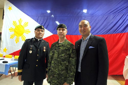 Canadian Forces Appreciation night for DART at the Filipino Canadian Seniors Hall on Euclid. Major Robert Meade came in from Ontario and was part of the Dart Team that helped in the last disaster in the Philippines. In photo Meade and Jon Reyes. BORIS MINKEVICH/WINNIPEG FREE PRESS  MARCH 5, 2014Canadian Forces Appreciation night for DART at the Filipino Canadian Seniors Hall on Euclid. Major Robert Meade came in from Ontario and was part of the Dart Team that helped in the last disaster in the Philippines. In photo Capt. Roy Allan C. Laudenorio, Major Robert Meade and Jon Reyes. BORIS MINKEVICH/WINNIPEG FREE PRESS  MARCH 5, 2014