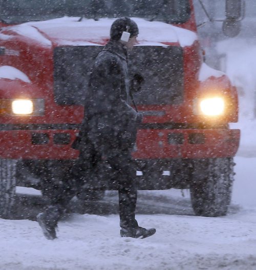 Stdup ,Pedestrians In the Hesdlights on Portage Ave , Fresh snow is still falling creating  low visibility conditions with mild temps have doubled stopping distances  even a slow speeds . Mar. 6 2014 / KEN GIGLIOTTI / WINNIPEG FREE PRESS