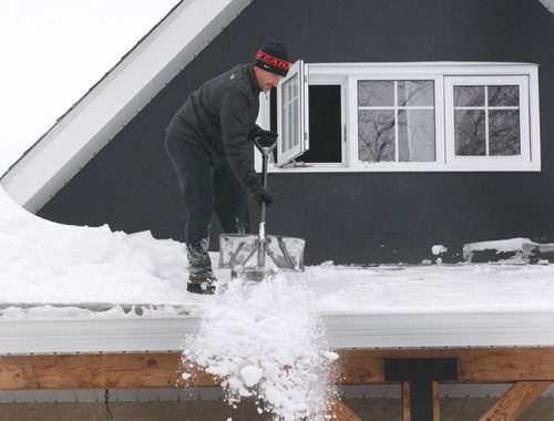 Meanwhile in Winnipeg- This man on Barlet Ave was busy cleaning snow off his roof-     Standup Photo-( Eds person refused name- I put it in as perhaps a need for future) Mar 06, 2014   (JOE BRYKSA / WINNIPEG FREE PRESS)