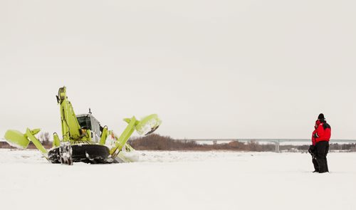 An Amphibex icebreaker uses the excavator arm to pull itself up out of the water, and on to the ice, using the weight of the machine to break the ice. Three Amphibex icebreakers are in use this season, through the end of March, to break up 30 km of ice on the Red River between Netley Lake and Selkirk. The breaking of the ice reduced the chances of ice jams along the river, which reduces the chances of flooding. Doug Speirs column 140305 - Wednesday, {month name} 05, 2014 - (Melissa Tait / Winnipeg Free Press)