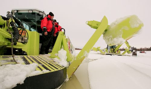 Doug Speirs (rear) and Brian Sparks on the deck of an Amphibex icebreaker near Selkirk. Three Amphibex icebreakers are in use this season, through the end of March, to break up 30 km of ice on the Red River between Netley Lake and Selkirk. The breaking of the ice reduced the chances of ice jams along the river, which reduces the chances of flooding. Doug Speirs column 140305 - Wednesday, {month name} 05, 2014 - (Melissa Tait / Winnipeg Free Press)