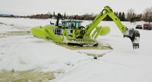 An Amphibex icebreaker is amphibious vehicle, with a propellor, balancing arms on either side and an excavator to pull the machine up onto the ice. Three Amphibex icebreakers are in use this season, through the end of March, to break up 30 km of ice on the Red River between Netley Lake and Selkirk. The breaking of the ice reduced the chances of ice jams along the river, which reduces the chances of flooding. Amphibex icebreaking - & Doug Speirs columm 140305 - Wednesday, {month name} 05, 2014 - (Melissa Tait / Winnipeg Free Press)