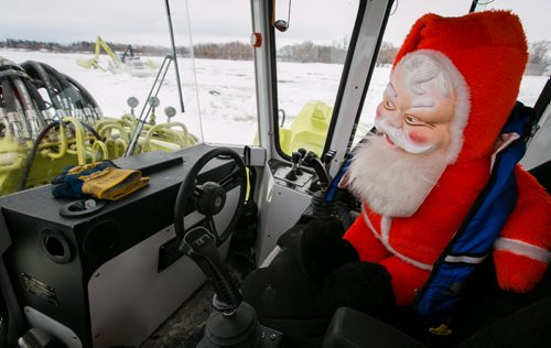Creepy Santa in the operator's seat of an Amphibex icebreaker on the Red River. Doug weather column. 140305 - Wednesday, {month name} 05, 2014 - (Melissa Tait / Winnipeg Free Press)