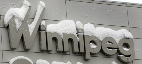 Snow accumulates on signage outside on the RBC Convention Centre Thursday with more in the forecast. Wayne Glowacki / Winnipeg Free Press March 6   2014