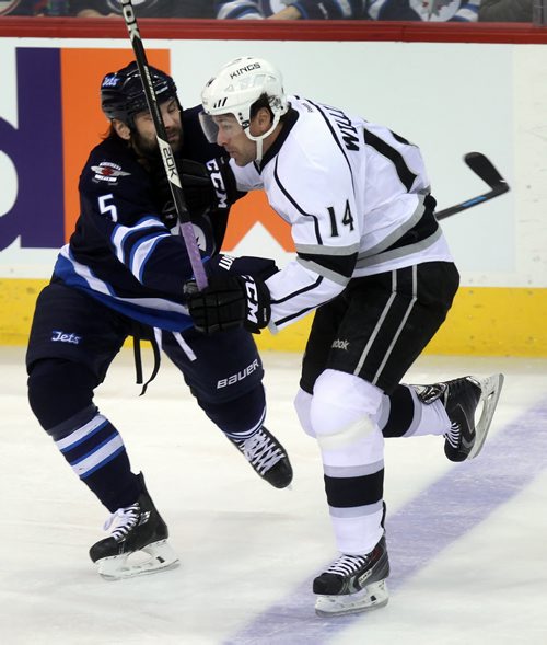 Winnipeg Jets Mark Stuart takes Los Angeles Kings Justin WIlliams out of the play in first period action at the MTS Center Thursday. See story. March 6, 2014 - (Phil Hossack / Winnipeg Free Press)