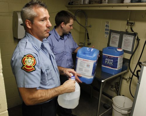 Update on City services relating to frozen water pipes. Winnipeg Fire Paramedic Service preparing water jugs for delivery at Winnipeg Fire and Paramedic Station 22, 1567 Waverley Street. In this photo Jay Simons and Dale Worrall demo on how they are gonna clean and fill the water jugs. BORIS MINKEVICH / WINNIPEG FREE PRESS  March 7, 2014