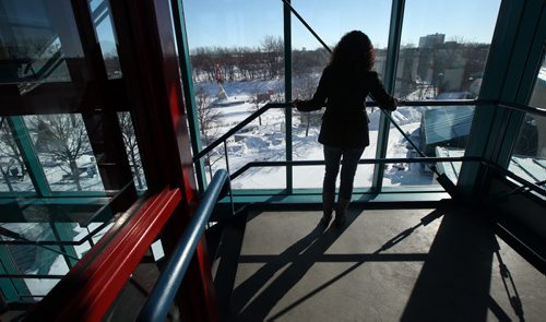 Photo of 55-year-old woman  atop the observation tower where she was robbed at gun point on a Saturday afternoon late last month. Photo has to be non-identifying so should be taken from behind looking out over the river ice and the skating rink she had gone up to photograph where the Jets would practice the next day. It also overlooks where a week later former Bison football player Sam Nemis would be attacked while cross-country skiing. STORY is about safety at The Forks and the lack of police  presence. See Gord Sinclair story. March 7, 2014 - (Phil Hossack / Winnipeg Free Press)