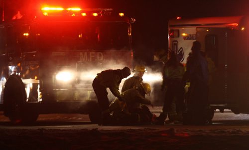 Emergency crews work on Hwy 101 approximately one km north of McGillivray Blvd to rescue those injured in a car that smashed into the rear of a flatbed semi trailer Friday night near 10 PM-   Breaking News- Mar 07, 2014   (JOE BRYKSA / WINNIPEG FREE PRESS)