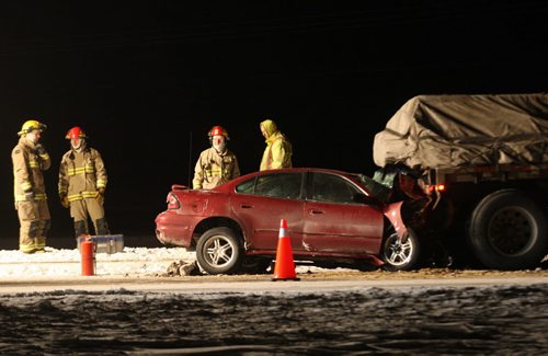 Emergency crews work on Hwy 101 approximately one km north of McGillivray Blvd to rescue those injured in a car that smashed into the rear of a flatbed semi trailer Friday night near 10 PM-   Breaking News- Mar 06, 2014   (JOE BRYKSA / WINNIPEG FREE PRESS)