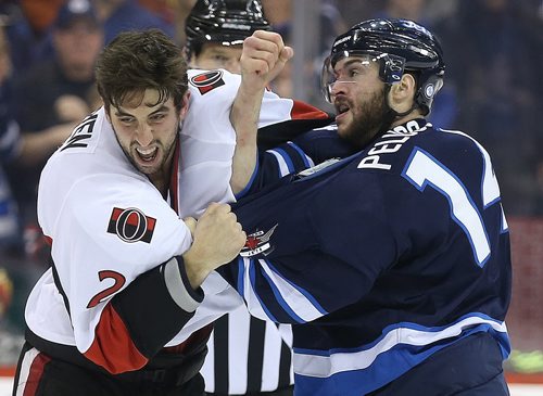Ottawa Senators' Jared Cowen (2) fights Winnipeg Jets' Anthony Peluso (14) during second period NHL hockey action at MTS Centre in Winnipeg, Saturday, March 8, 2014. (TREVOR HAGAN/WINNIPEG FREE PRESS)
