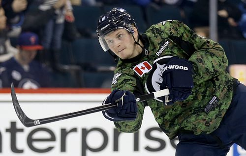Winnipeg Jets' Jacob Trouba (8) fires a shot during warmup while wearing a camouflage jersey on Military Appreciation day prior to the game against the Ottawa Senators', Saturday, March 8, 2014. (TREVOR HAGAN/WINNIPEG FREE PRESS)