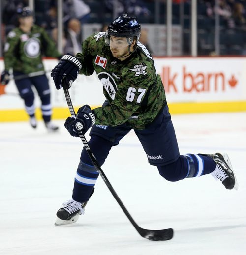 Winnipeg Jets' Michael Frolik (67) fires a shot during warmup while wearing a camouflage jersey on Military Appreciation day prior to the game against the Ottawa Senators', Saturday, March 8, 2014. (TREVOR HAGAN/WINNIPEG FREE PRESS)