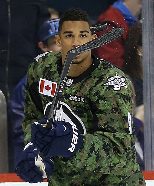 Winnipeg Jets' Evander Kane (9) juggles the puck during warmup while wearing a camouflage jersey on Military Appreciation day prior to the game against the Ottawa Senators', Saturday, March 8, 2014. (TREVOR HAGAN/WINNIPEG FREE PRESS)