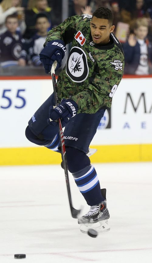 Winnipeg Jets' Evander Kane (9)  fires a shot during warmup while wearing a camouflage jersey on Military Appreciation day prior to the game against the Ottawa Senators', Saturday, March 8, 2014. (TREVOR HAGAN/WINNIPEG FREE PRESS)