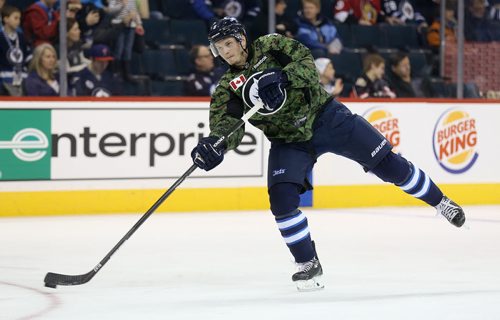 Winnipeg Jets' Jacob Trouba (8) fires a shot during warmup while wearing a camouflage jersey on Military Appreciation day prior to the game against the Ottawa Senators', Saturday, March 8, 2014. (TREVOR HAGAN/WINNIPEG FREE PRESS)