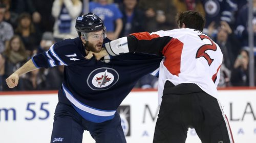 Winnipeg Jets' Anthony Peluso (14) fights Ottawa Senators' Jared Cowen (2) during second period NHL hockey action at MTS Centre in Winnipeg, Saturday, March 8, 2014. (TREVOR HAGAN/WINNIPEG FREE PRESS)