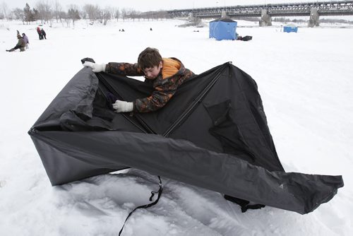 March 9, 2014 - 140309  - Cullen MacKenzie dismantles his portable ice fishing hut after a day of ice fishing with his mom on the Red River just north of Lockport Sunday, March 9, 2014. Ice fishers must remove their huts by the end of today. John Woods / Winnipeg Free Press