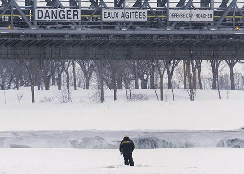 March 9, 2014 - 140309  - An ice fisher drops a line just north of Lockport Sunday, March 9, 2014. Ice fishers must remove their huts by the end of today. John Woods / Winnipeg Free Press