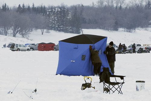 March 9, 2014 - 140309  - A couple assemble a portable ice fishing hut just north of Lockport Sunday, March 9, 2014. Ice fishers must remove their huts by the end of today. John Woods / Winnipeg Free Press