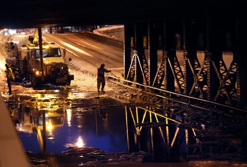 A city crew work to drain the flooded McPhillips Street underpass after a Monday morning water main break near Logan Ave. South and north bound lanes are  closed to traffic. Wayne Glowacki / Winnipeg Free Press March 10   2014