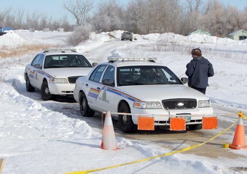 RCMP continue to investigate a death on a property on McGillivray Boulevard, between Kenaston Boulevard and McCreary Road. BORIS MINKEVICH / WINNIPEG FREE PRESS  March 10, 2014