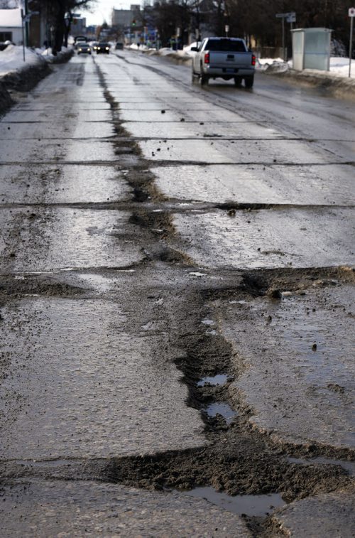 City Infrastructure story Äì large pothole crevasses appear on Salter St   Mar. 10 2014 / KEN GIGLIOTTI / WINNIPEG FREE PRESS