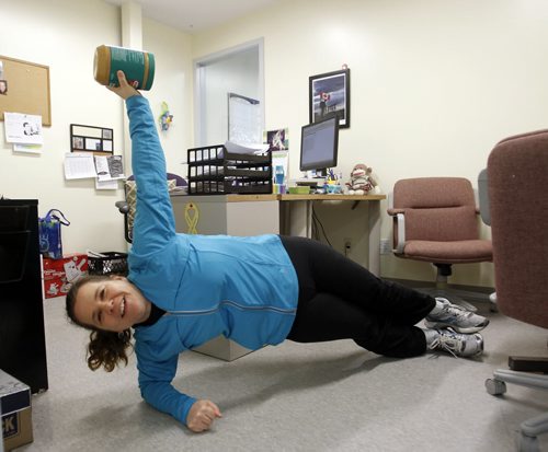 49.8 Training Basket.     Tammy Watson, Winnipeg Harvest's volunteer services coordinator does some exercises to keep fit.   Here  she does side plank using peanut butter for weight. Ashley Prest story     Wayne Glowacki / Winnipeg Free Press March 10   2014