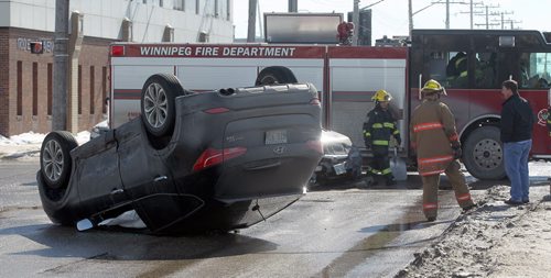 One of two vehicles involved in a collision at Century and Ellice rests on its roof MOnday afternoon. Wasn't able to get any info re: injuries etc at the scene. March 10, 2014 - (Phil Hossack / Winipeg Free Press)