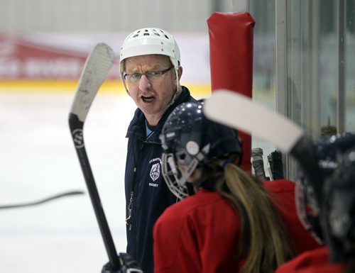 Coach Larry Bumstead works his team at a St Mary's Academy team practice Monday. St. Marys Academy Flames school prep team is practicing in advance of the tournament at Iceplex later this week, the Female World Sport School Challenge, which will feature female prep hockey teams from across Canada. See Melissa Martin's story. March 10, 2014 - (Phil Hossack / Winipeg Free Press)