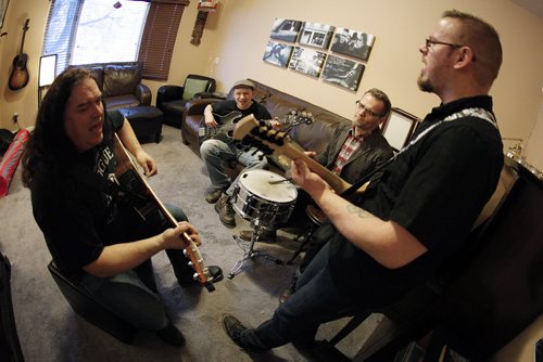 March 10, 2014 - 140310 -  Dust Rhinos Blair McEvoy (guitar), Dan Cannon (bass/fiddle), Darren Wittmann (drums), Dale Brown (mandolin) and Andy Bart (fiddle - missing) rehearse in McEvoy's house Monday, March 10, 2014. John Woods / Winnipeg Free Press