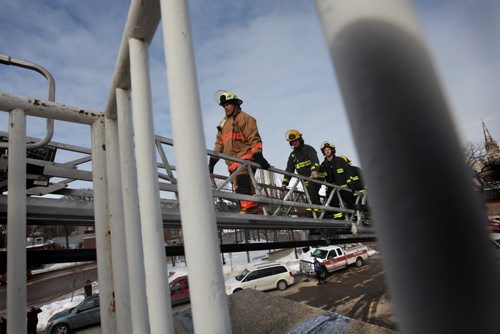 Fire Fighters take to the roof of the Osborne Village Fire Hall to begin their annual 72 hour fundraising campaign called  Rooftop Campout, in support of Muscular Dystrophy. Retried Fire Fighter Alan Bartley is the first of the four to walk up the ladder to the rooftop followed by  Chad Swayze, Mike Lisowick and Ben Ritchie.  March 11, 2014 Ruth Bonneville / Winnipeg Free Press