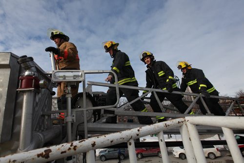 Fire Fighters take to the roof of the Osborne Village Fire Hall to begin their annual 72 hour fundraising campaign called  Rooftop Campout, in support of Muscular Dystrophy. Retried Fire Fighter Alan Bartley is the first of the four to walk up the ladder to the rooftop followed by  Chad Swayze, Mike Lisowick and Ben Ritchie.  March 11, 2014 Ruth Bonneville / Winnipeg Free Press