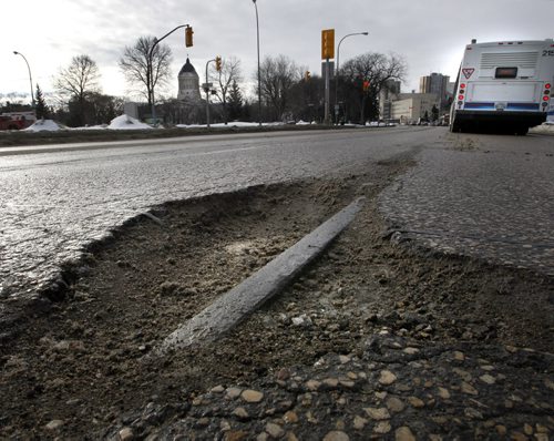 Motorists travelling southbound on Osborne St. near the Manitoba Legislative building Tuesday have an opportunity to see in one of the potholes what appears to be an uncovered portion of the old streetcar track used over fifty years ago.     Wayne Glowacki / Winnipeg Free Press March 11   2014