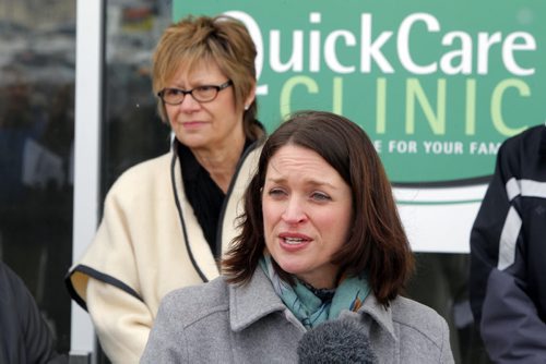 QUICKCARE CLINICS - Initiatives to help ensure all Manitobans have access to a family doctor by 2015 and location of a new QuickCare Clinic. In front of future clinic. Health Minister Erin Selby addresses the media. In behind is Nancy Allan, MLA. BORIS MINKEVICH / WINNIPEG FREE PRESS  March 11, 2014
