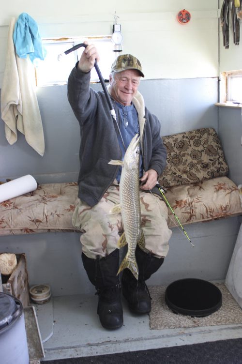 Ernie Welburn pulls out a 1.14 kilogram pike jack fish. Story is how fish have found theIr way into  the Shoal Lakes in the Interlake for the first time in living memory, thanks to flooding.  It's the consolation prize for farmers who have been flooded out. March 10 2014. Bill Redekop story / photo / Winnipeg Free Press.