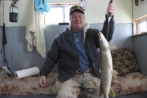 Ernie Welburn pulls out a 1.14 kilogram pike jack fish. Story is how fish have found theIr way into  the Shoal Lakes in the Interlake for the first time in living memory, thanks to flooding.  It's the consolation prize for farmers who have been flooded out. March 10 2014. Bill Redekop story / photo / Winnipeg Free Press.