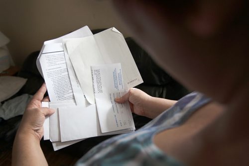 Our money makeover family looks at bills in her home-   See story- Mar 12, 2014   (JOE BRYKSA / WINNIPEG FREE PRESS)