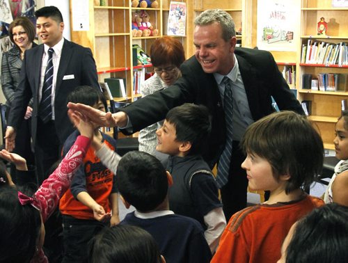 In the library at École Sacré-Coeur Wednesday, Education and Advanced Learning Minister James Allum meets with students after he made an announcement to support creating smaller kindergarten to grade 3 class sizes with the second phase of its plan to add additional classrooms in Manitoba.  He announced the investment of over $12.4 million to renovate or build 21 classrooms in eight schools across the province. See release Wayne Glowacki / Winnipeg Free Press March 12   2014
