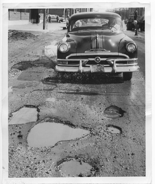 Winnipeg Free Press Archives April 4, 1956 Potholes like this beauty on Corydon Avenue near Stafford Street are the plague of the Winnipeg's city engineering department these days which can offer no permanent solution for them until the streets dry out. One crew is charged with filling up the worst potholes with a temporary mixture until permanent patches can be applied later on.