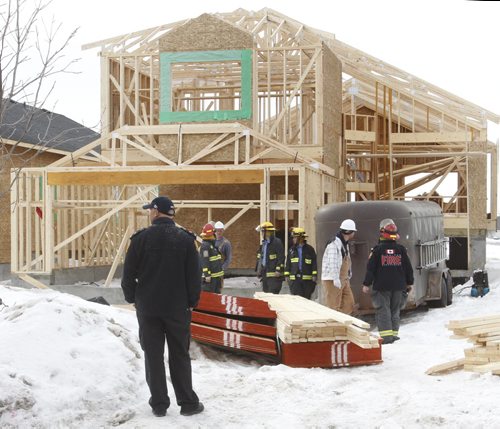 Winnipeg Fire Dept. at the scene of a house construction site on Amber Trail Thursday morning where a worker was sent to the hospital after being crushed by roof trusses. The Fire Fighters used a chain saw to free him.  Wayne Glowacki / Winnipeg Free Press March 13   2014
