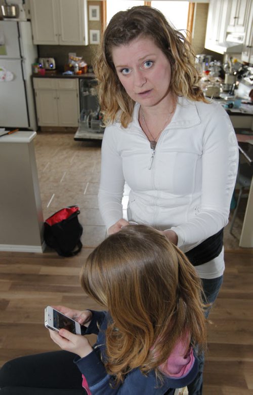 Sarah Phillips demonstrating her remedy to get rid of mutant lice. Shell be using her daughter. Shes got full time work, doing this: head by head. she lubricates with mint oil and picks the bugs and nits off strand by strand. BORIS MINKEVICH / WINNIPEG FREE PRESS  March 12, 2014 Louse