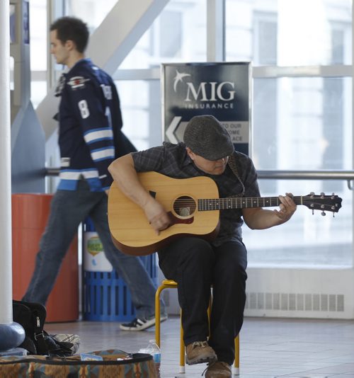 Tim Miyai, a busker in the skywalk over leading from MTS Centre to Portage Place Mall prior to the Winnipeg Jets versus New York Rangers NHL game in Winnipeg, Friday, March 14, 2014. (TREVOR HAGAN/WINNIPEG FREE PRESS) - dave sanderson story