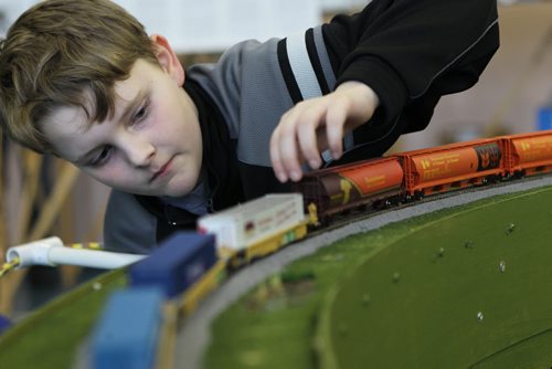Tommy South one of the youngest members of  The Winnipeg Model Railroad Club  adjusts one of the cars on the train track at the annual Open House  at   Westworth United Church,Saturday, The Show runs March 15 - 11:00 am to 4:00 pm and  Sunday, March 16 - 1:00 pm to 5:00 pm  Standup photo  March 15, 2014 Ruth Bonneville / Winnipeg Free Press