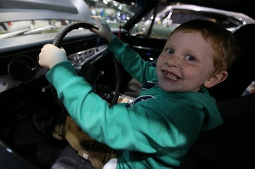 Declan Keown, 7, in a 1969 Plymouth Barracuda owned by Barry Grzebeniak at the World of Wheels Car show at the Convention Centre, Saturday, March 15, 2014. (TREVOR HAGAN/WINNIPEG FREE PRESS)