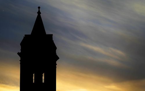 The Young United Church tower is silhouette in front of the last light of the day, Saturday, March 15, 2014. (TREVOR HAGAN/WINNIPEG FREE PRESS)