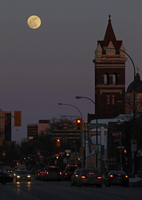 The moon rises behind the Young United Church tower along Broadway, Saturday, March 15, 2014. (TREVOR HAGAN/WINNIPEG FREE PRESS)